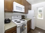 Thumbnail 4 of 28 - White Appliances in Kitchen at Eucalyptus Grove Apartments, Chula Vista, CA, 91910